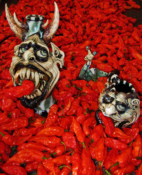 demon heads eating hot chilli peppers